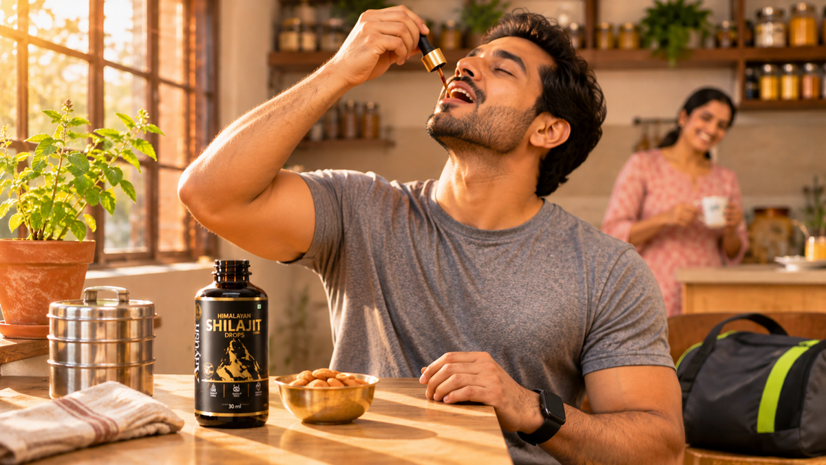 Indian man taking Aayush Himalayan Shilajit Drops in a sunlit kitchen, black dropper bottle with gold collar on the counter